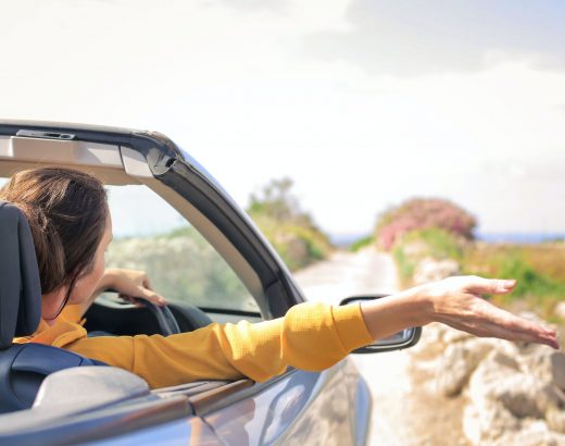 woman in yellow long sleeve driving car