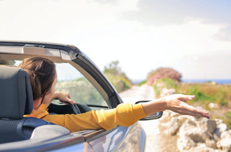 woman in yellow long sleeve driving car